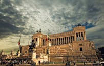 Stunning view of the Victor Emmanuel II Monument in Rome under dramatic skies.